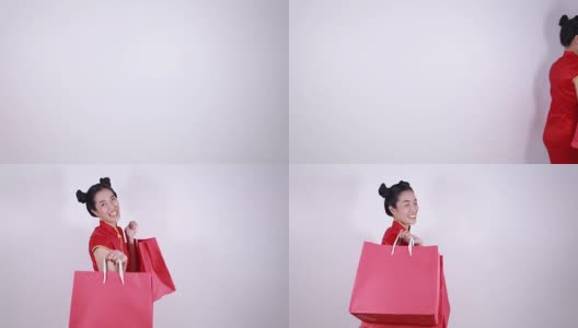 在中国新年庆祝活动中，一个拿着购物袋走路的女人高清在线视频素材下载