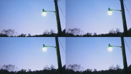 黄昏时分，公园里一根杆子上明亮的路灯高清在线视频素材下载