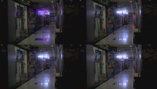 在中国，霓虹灯闪烁的漫长昏暗的室内走廊。高清在线视频素材下载