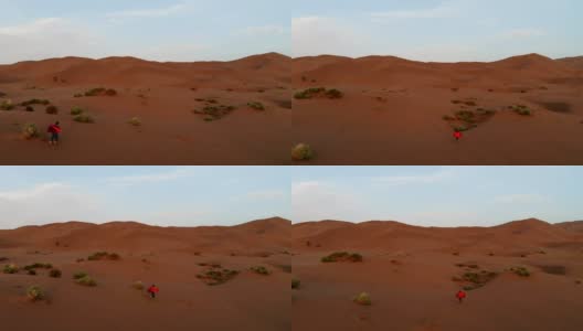 超级英雄在沙漠中徒步旅行的鸟瞰图高清在线视频素材下载