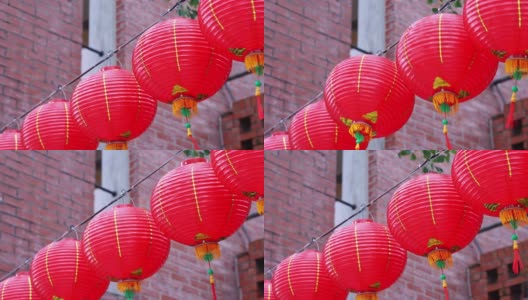美丽的圆红灯笼挂在古老的传统大街上，是中国农历新年节日的概念。高清在线视频素材下载