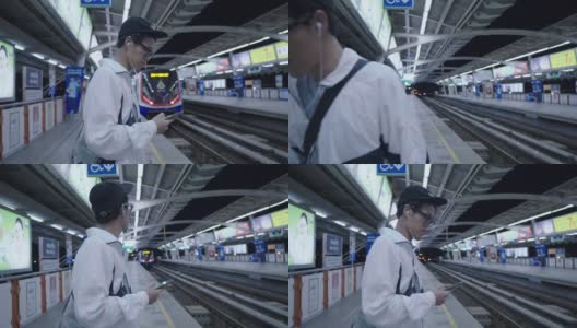 亚洲男子在火车上用智能手机使用社交媒体高清在线视频素材下载