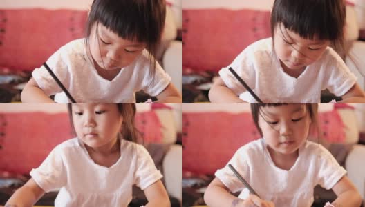一个亚洲女孩在家画画高清在线视频素材下载