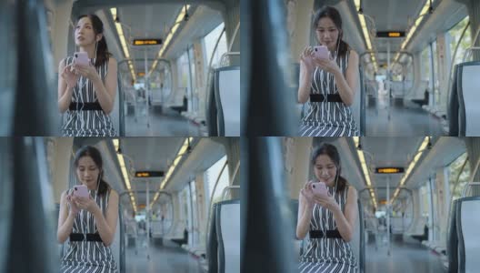 年轻女子在乘坐地铁上下班时使用手机高清在线视频素材下载