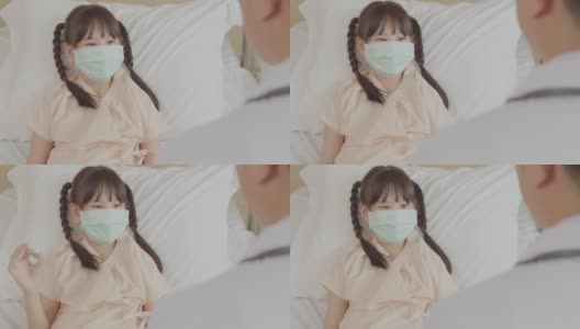 亚洲女孩病人与医生表现出OK的迹象，说她康复了。高清在线视频素材下载