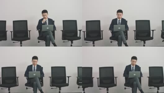 年轻的亚洲求职者坐在椅子上等待面试高清在线视频素材下载