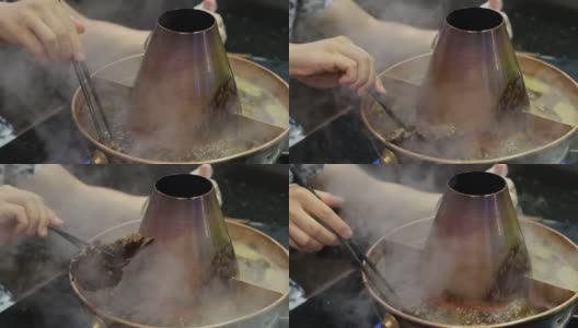 人们吃着传统的中国羊肉火锅高清在线视频素材下载
