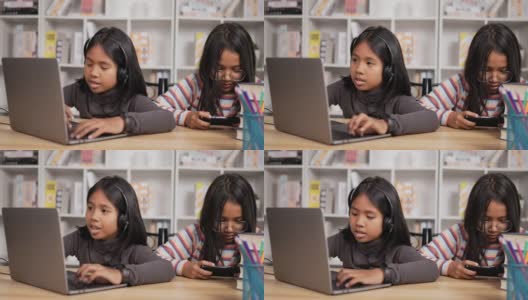 两个女孩在网上学习，在家用智能手机玩游戏高清在线视频素材下载