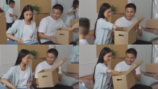 快乐的日本家庭收拾移动箱子坐在室内高清在线视频素材下载