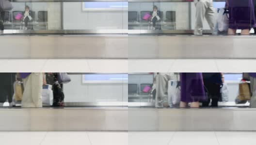 慢镜头模糊了在机场候机楼机械步道上移动的人、游客或乘客高清在线视频素材下载