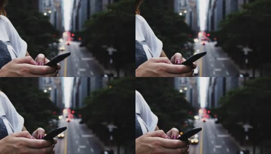 在美国纽约的一座桥上，女性手握手机的特写镜头高清在线视频素材下载