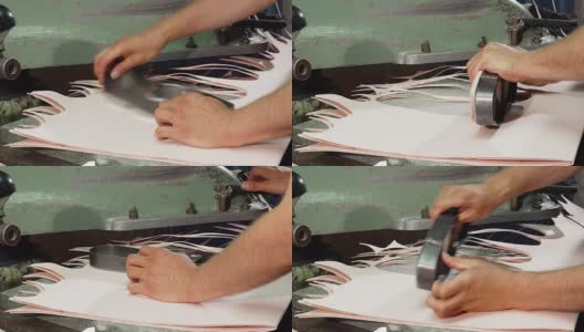 工匠在制鞋时使用内底切割机高清在线视频素材下载
