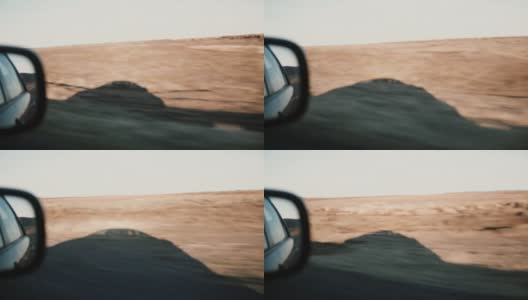 在沙漠上的乡村道路上的汽车内视图。窗外的车影，美丽的晚霞高清在线视频素材下载