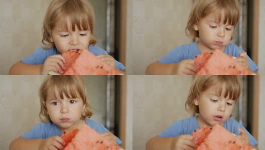 一个小男孩正在吃一个大西瓜。孩子吃西瓜片的肖像。4 k UHD。高清在线视频素材下载