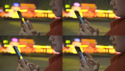 中国春节期间，女人用智能手机与城市景观高清在线视频素材下载
