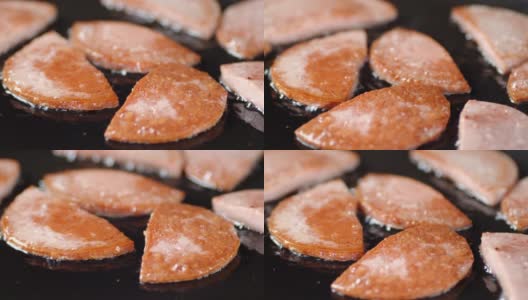 香肠片在平底锅里用油煎。高清在线视频素材下载