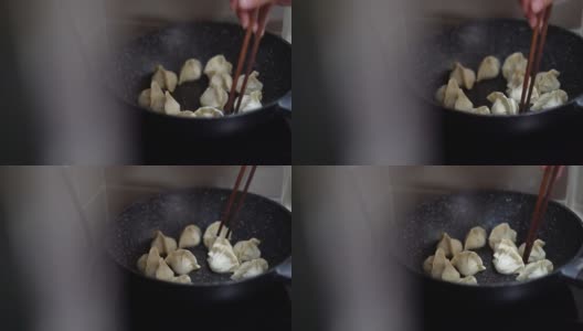在厨房用电炉煎饺子高清在线视频素材下载