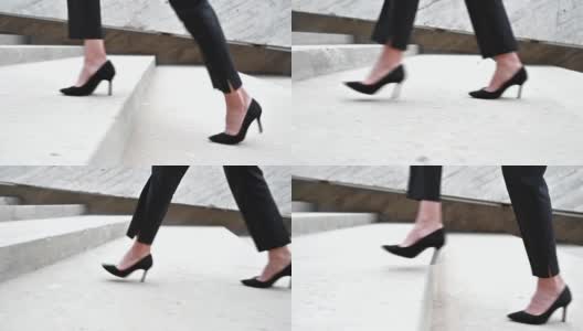 女商人穿着高跟鞋在城市里爬楼梯。腿的近景。高质量的全高清镜头高清在线视频素材下载