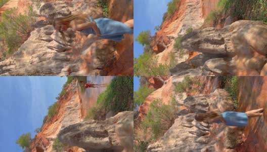 垂直视频。Slowmotion射杀。在越南南部的梅内村，一名女游客正在参观沙漠边界的红峡谷或仙女溪。用手机拍摄高清在线视频素材下载