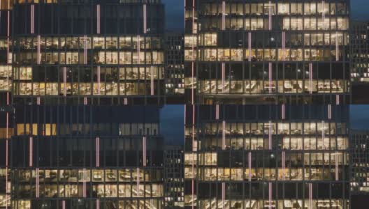 夜晚摩天大楼办公室窗户的电影鸟瞰图。高清在线视频素材下载