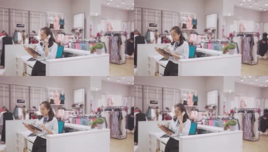 亚洲华人服装店女老板在收银台接听固定电话高清在线视频素材下载