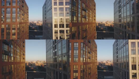 日落时分，镜头在两座办公大楼之间穿梭。阳光反射在窗户上高清在线视频素材下载
