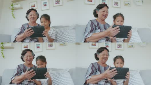 孙女正在客厅里帮奶奶用ipad。高清在线视频素材下载