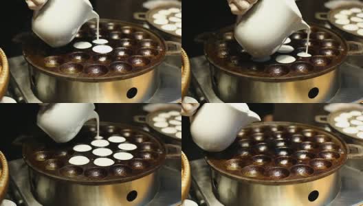 热椰子饺子半球在热金属板圆形形状，泰国名kanom krog，并等待煮沸高清在线视频素材下载