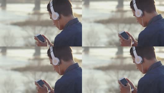 一个十几岁男孩戴着耳机听音乐的特写镜头高清在线视频素材下载