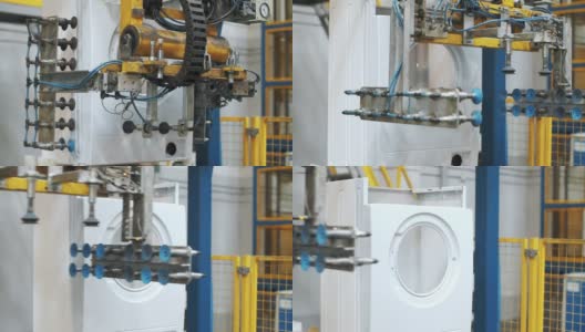 在工业工厂的机器人设备上装配洗衣机高清在线视频素材下载