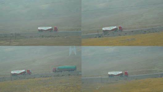 慢镜头:在浓雾弥漫的西藏，一辆货车拖着一个水箱行驶在一条路上。高清在线视频素材下载