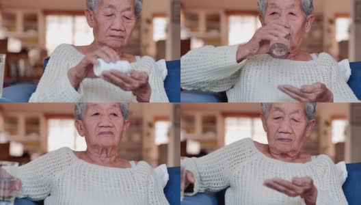 肖像亚洲老年妇女有一个感觉不舒服和服用药丸为她的健康或在家服用维生素。医疗，护理，退休，生活方式，医疗保健和医药，老年人保健，人寿保险，科学，药学概念，生病。高清在线视频素材下载
