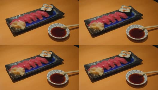 美味的日本料理，金枪鱼寿司配三文鱼卷小盘高清在线视频素材下载