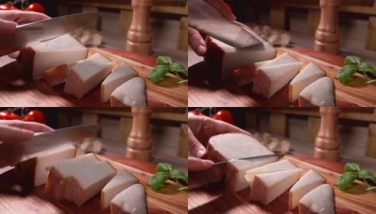 把半硬的羊奶酪切成小块的手的特写高清在线视频素材下载