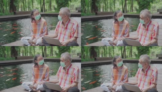 一对亚洲老年夫妇戴着外科口罩坐在地板上聊天高清在线视频素材下载