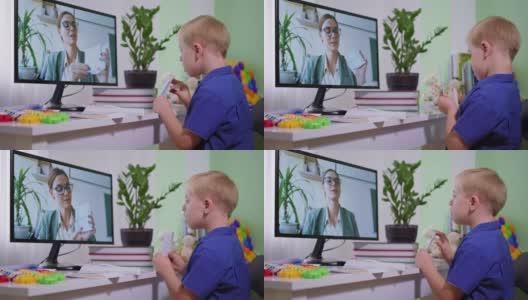远程教学，残疾学童在疫情期间与老师用电脑通过网络摄像头进行视频通话高清在线视频素材下载