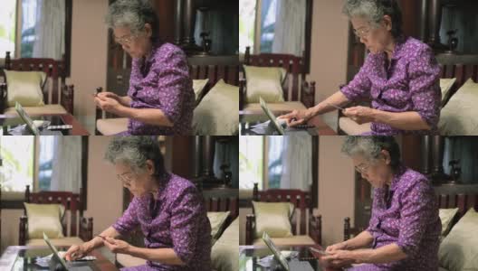 奶奶用药片寻找药物信息高清在线视频素材下载