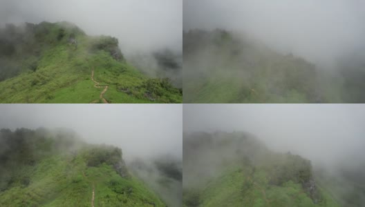 在雾天由无人机的绿色雨林山的鸟瞰图高清在线视频素材下载