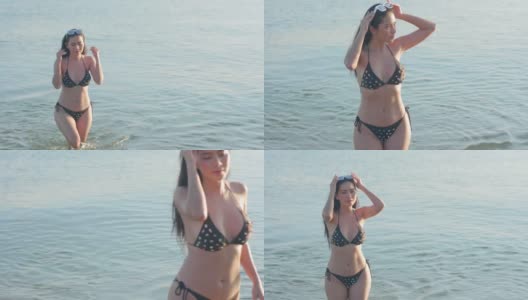 身材匀称的亚洲美女在海滩上玩比基尼的海。阳光照在身上高清在线视频素材下载