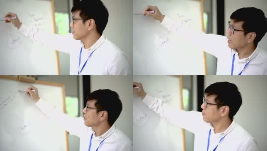 男亚裔教师在白板上教学高清在线视频素材下载