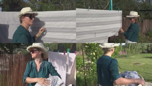 一个妇女在后院把湿衣服晾在晒衣绳上高清在线视频素材下载