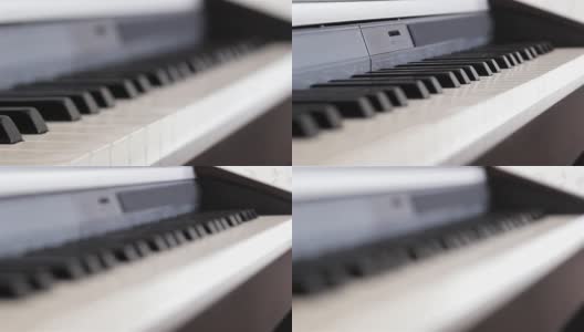 钢琴键盘微距视频拍摄。近距离观察钢琴琴键。近距离观察钢琴的琴键。白色和黑色的琴键。高清在线视频素材下载