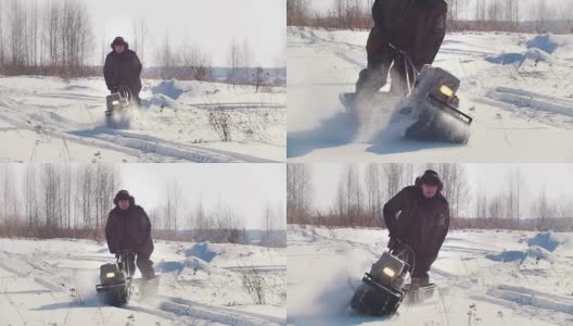 冬天，穿着冬衣的人骑着小型履带式雪地摩托在雪地里穿行高清在线视频素材下载