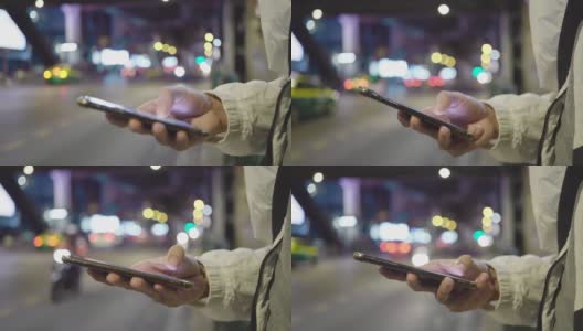 年轻的亚洲男子在晚上用手机打出租车高清在线视频素材下载