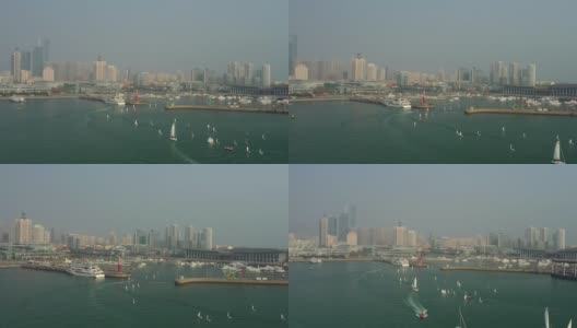 晴朗的夜晚，青岛市内著名的奥运帆船交通湾码头航拍全景4k中国高清在线视频素材下载