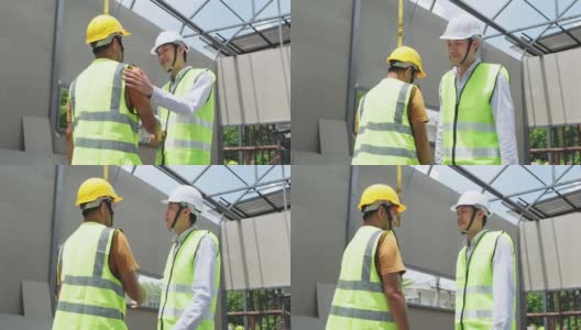 中等拍摄的亚洲同事，工人，人们在建筑现场工作。男工头工程师在施工方检查工作进度，领导在讲解项目情况。高清在线视频素材下载