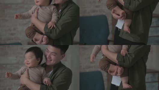 一位父亲抱着一个一岁的无辜儿子，紧紧地拥抱着他的小腿高清在线视频素材下载