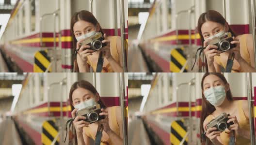在曼谷的屋顶上，微笑的年轻漂亮女人在用电话。女性用手机做视频博客，在社交媒体上生活。高清在线视频素材下载