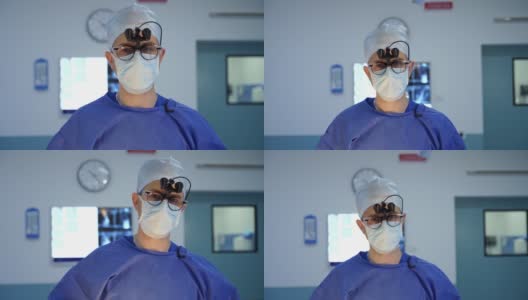 戴眼镜的医生肖像。外科医生戴着双筒放大镜，在手术室对着摄像机讲话。高清在线视频素材下载
