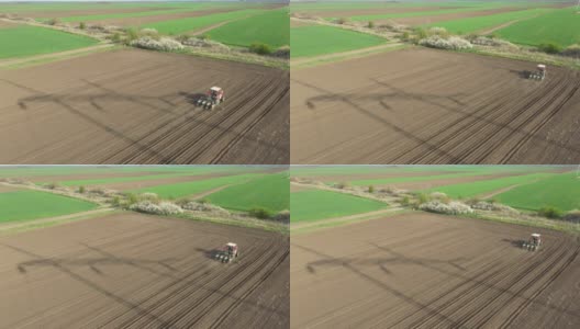 俯视图的拖拉机拖动播种机在农业领域，农田高清在线视频素材下载